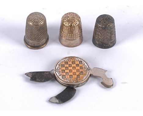 A vintage art deco manicure set in a disc,  decorated with geometric patterns and motifs, containing three tools, marked 'M. 