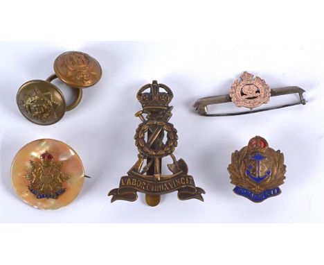 A collection of military cap badges, comprising a chrome, enamel and mother of pearl Border Reg lapel badge, chrome and ename