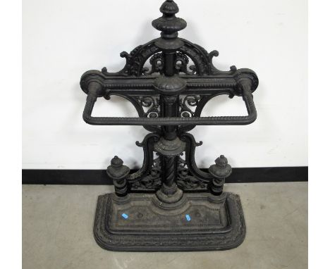 A Victorian style cast iron stick stand,  elaborate pierced design to back and  a  lift out drip tray, 57cm x 23cm x 82cm 