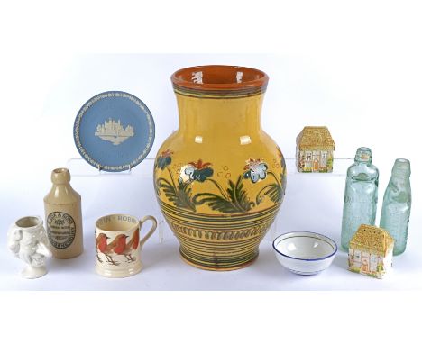 A large studio pottery vase, flared neck, decorated with blue flowers on a yellow glaze, together with a pair of salt and pep