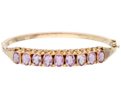 14K Rose gold bangle bracelet set with approx. 5.40 ct. amethyst. Set with nine oval-cut amethysts measuring approx. 9 x 0.60