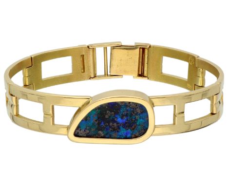 18K Yellow gold link bracelet boulder opal filled with resin. Link bracelet with symmetrical openwork links. Set with a bould