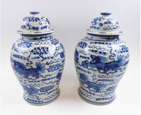 ORIENTAL TEMPLE JARS, a pair, blue and white ceramic, decorated stylised dragons, each 42cm H. (2)