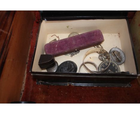 A box containing a silver pendant; silver locket; jet brooch; cased silver thimble; pocket watch; silver bangles etc.