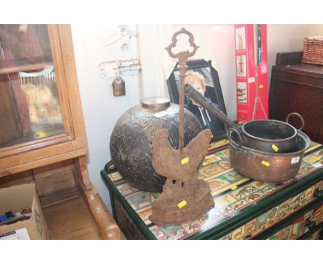 A brass light shade together with a cast iron door stop in the form of a chicken