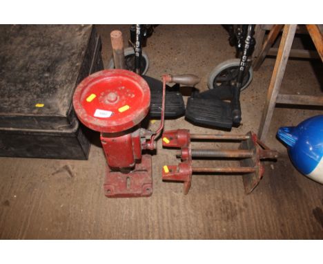 A bench vice together with a hand powered drill 