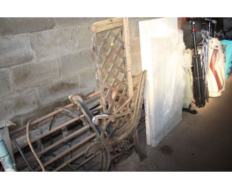 A pair of metal bench ends and a back rest 