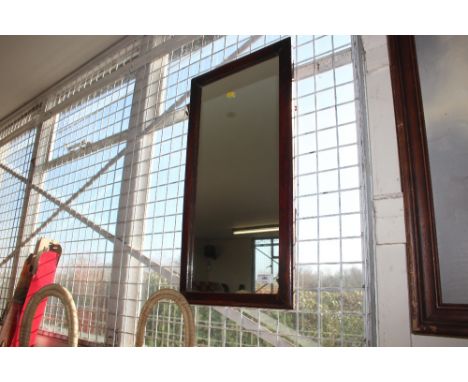 A framed oblong wall mirror