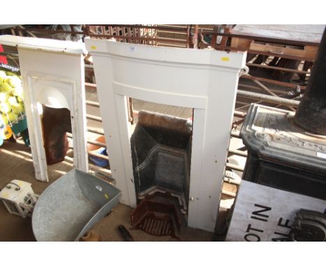 A white painted cast iron fire surround