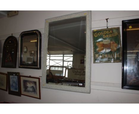 A framed bevel edged wall mirror
