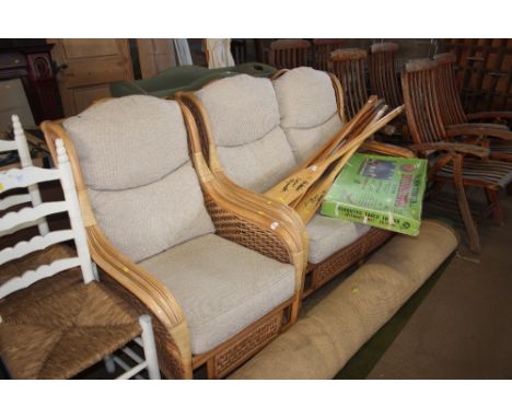 A conservatory suite comprising of a two seater sofa with matching arm chair 