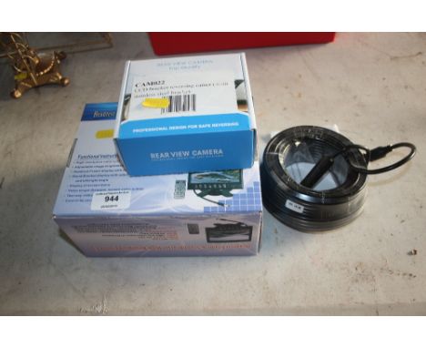 A car head rest; a television with reversing camera and bracket