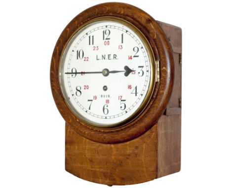 North Eastern Railway 8-inch oak cased iron dial railway clock with a cast brass bezel manufactured for the NER by Reid & Son