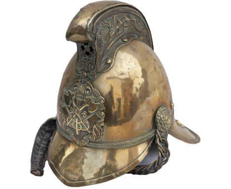 A Victorian original brass fireman's helmet, in the Merryweather pattern with crossed axes & torch badge on the front, dragon