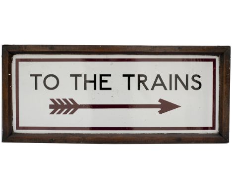 Underground enamel sign in original wooden frame TO THE TRAINS, with Right pointing feathered arrow, in the classic Johnston 