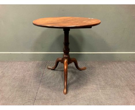 A George III mahogany tripod table, the circular tilt-top above a turned column support raised on cabriole legs with pointed 