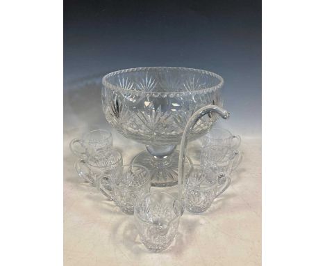 A large cut glass punch bowl on stand, six glasses and a ladle