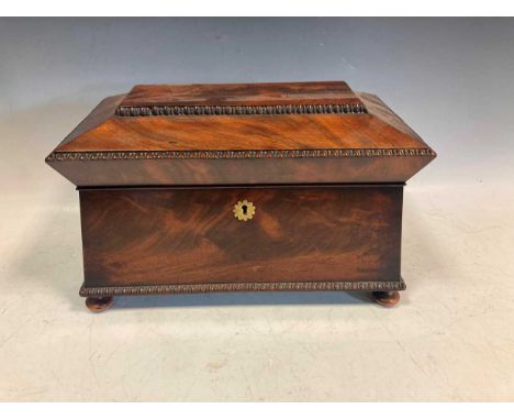 An early 19th century flame mahogany sarcophogus shaped tea caddy with bead moulded edge, 21 x 35 x 19cmProvenance:Property o