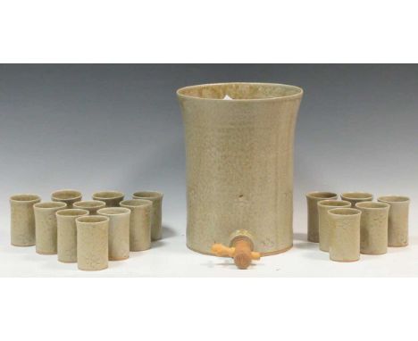 A ceramic punch bowl with a wooden spout, 30cm high and matching ceramic cups (qty)