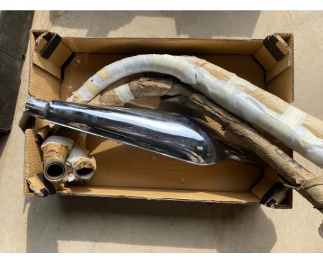 A Norton Dominator silencer and two exhaust down pipes, nos, plus one used exhaust down pipe.