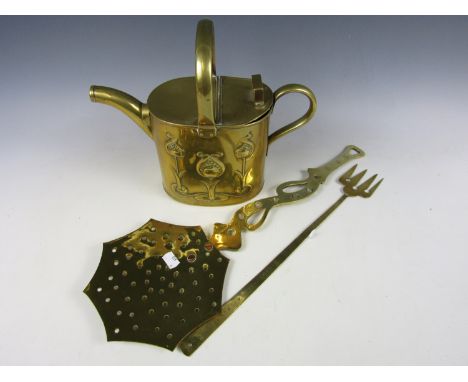 An Art Nouveau style brass watering can together with a skillet and a toasting fork
