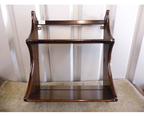 An Ercol oak hanging shelf