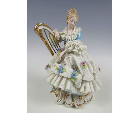 A Capodimonte figurine of a crinoline lady with harp