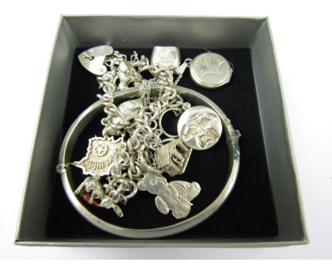 A silver charm bracelet together with a locket and hinged bangle