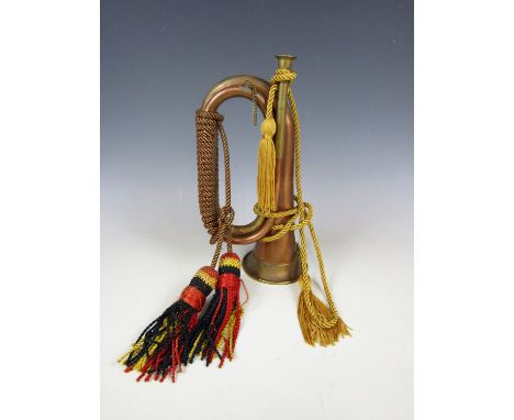 A reproduction copper and brass bugle with tassels