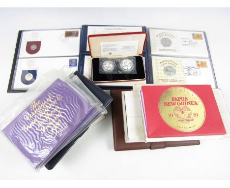 A large quantity of commemorative issue first day cover coin sets, including John Pinches' Day of the Concorde and Apollo-Soy