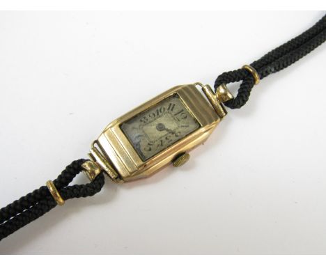 An early 20th Century lady's 9ct gold cased wristwatch, with Swiss made 15 jewel movement, engine-turned silvered face and Ar