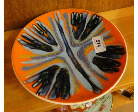 A Poole Pottery plate with painted abstract design.