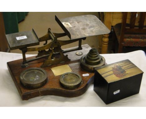 Postal scale and weights and a lacquer tea caddy with painted lid.