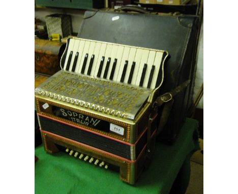 A Soprani Italia piano accordion with case.