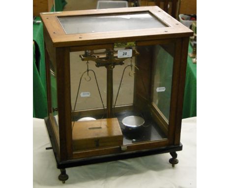 An Oertling cased balance scale and weights.