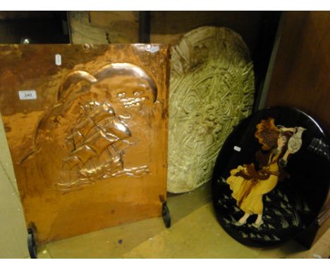 A copper firescreen with sailing ship design, a moulded plaque and an oval portrait.
