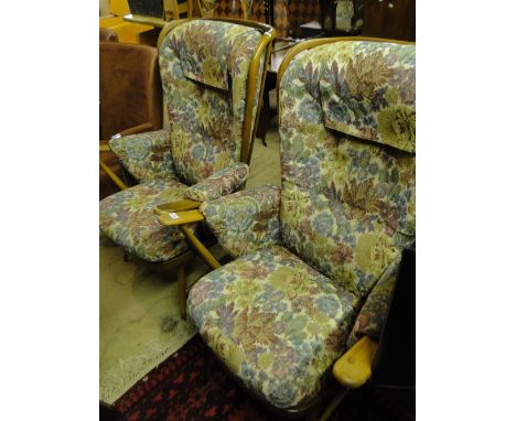 A pair of Ercol Windsor design armchairs with upholstered cushions, stained beech frames.