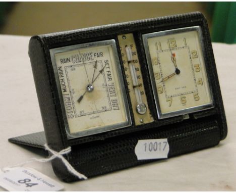 A leather cased Le Coultre travel clock, thermometer and barometer.