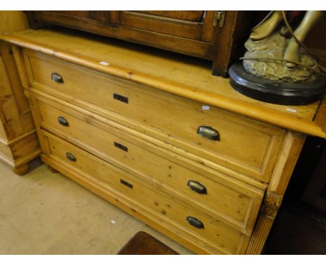 An Antique continental pine 3-drawer commode on bun feet, length 4'10".