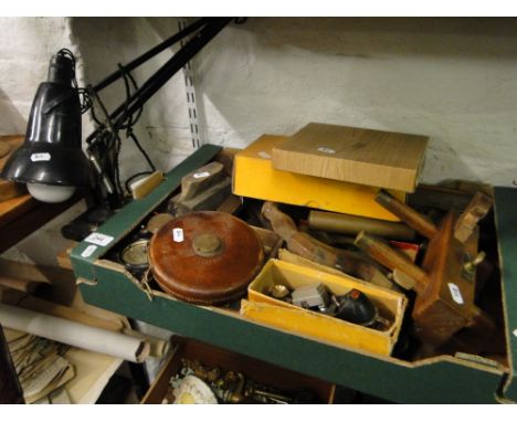 Surveyor's tape, carpenter's plane and other tools.
