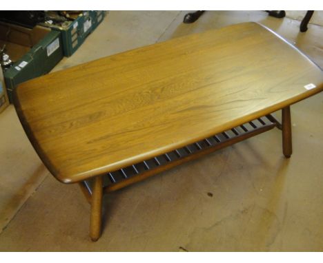 An Ercol elm coffee table with magazine under tier, 3'5" wide.