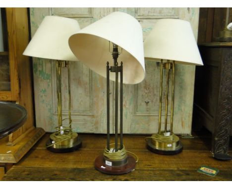 A pair of tall brass table lamps and shades and a similar lamp, (3).