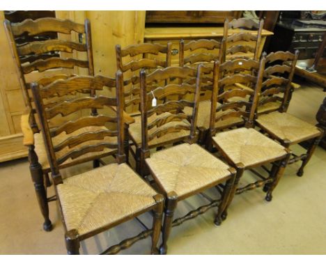 A set of 8 reproduction oak ladder back dining chairs,with rush seats and turned legs, (6+2).