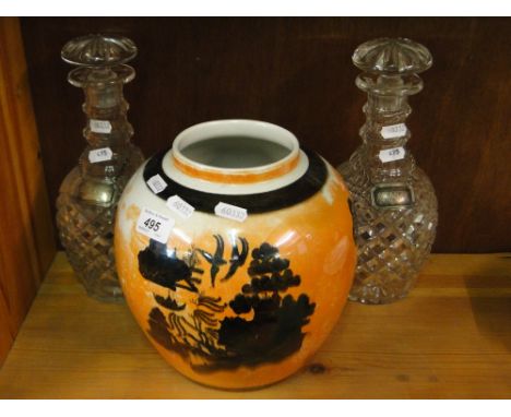 Carltonware lustre jar and a pair of cut-glass decanters and stoppers with plated labels.