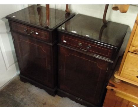 Pair of reproduction mahogany pedestal cabinets with drawer and cupboards on bracket feet.