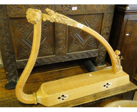 A carved Celtic table harp for re-stringing.
