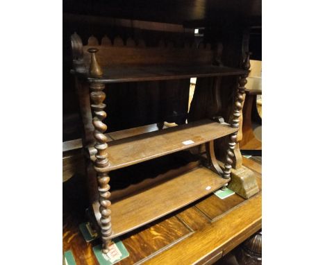 A stained wood 3-tier hanging shelf.