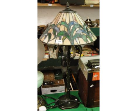 A palm tree design table lamp with Tiffany style shade.