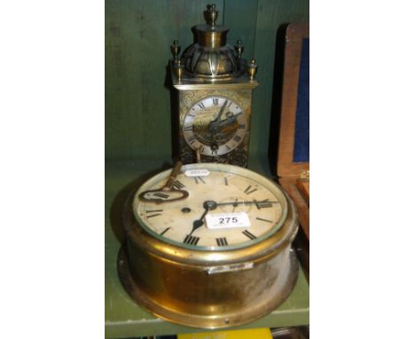A brass ships bulkhead clock and a lantern clock.