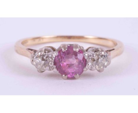 An 18ct yellow gold &amp; platinum three stone ring set with a round cut pink sapphire or ruby? (fracture filled), approx. 0.